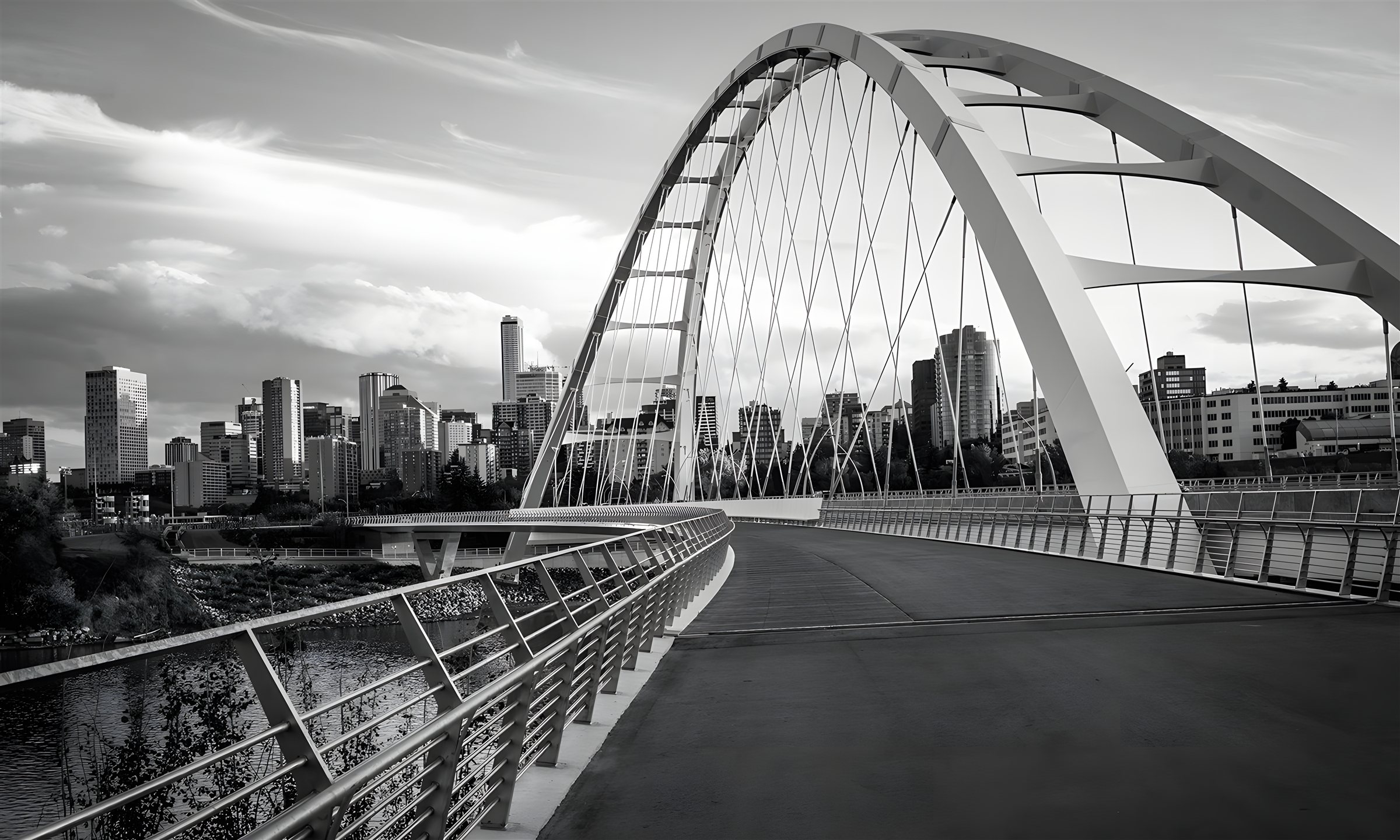 The Walterdale Bridge arching over the North Saskatchewan River with the downtown Edmonton skyline behind